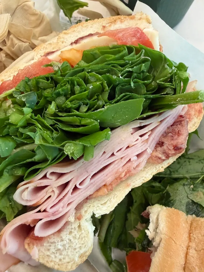 Cranberry jambon-beurre with added cheese, rocket and tomato