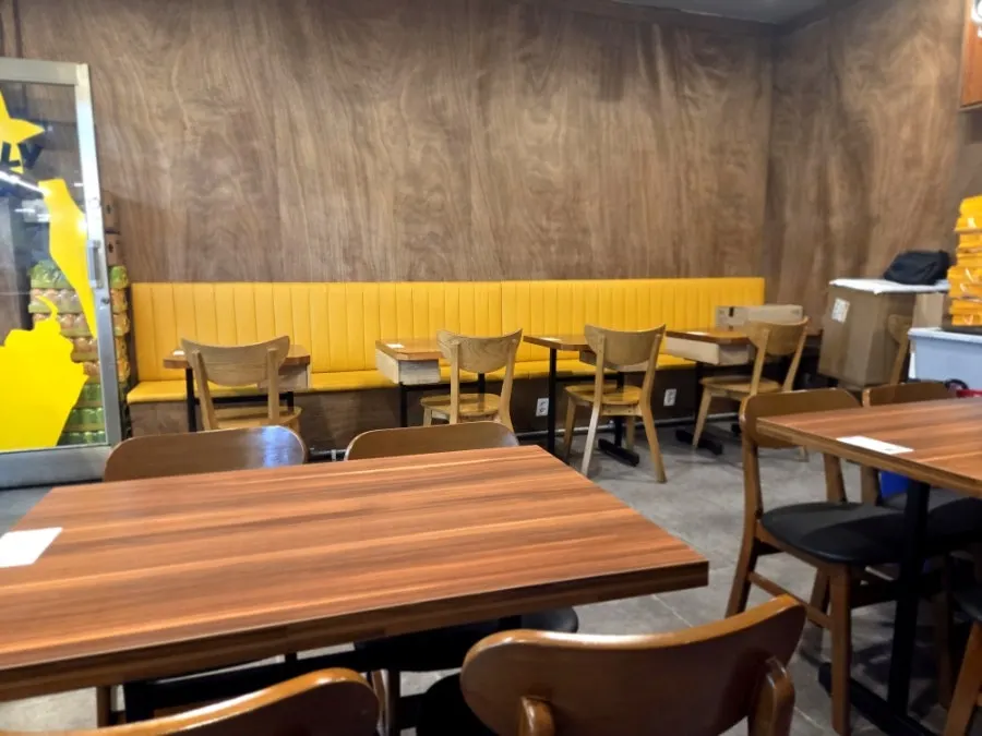 Interior with yellow accent signage and wood-toned decor