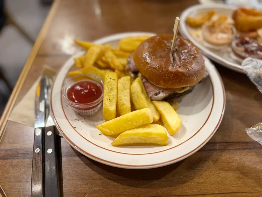 Bacon cheeseburger plated together with 18 Fries