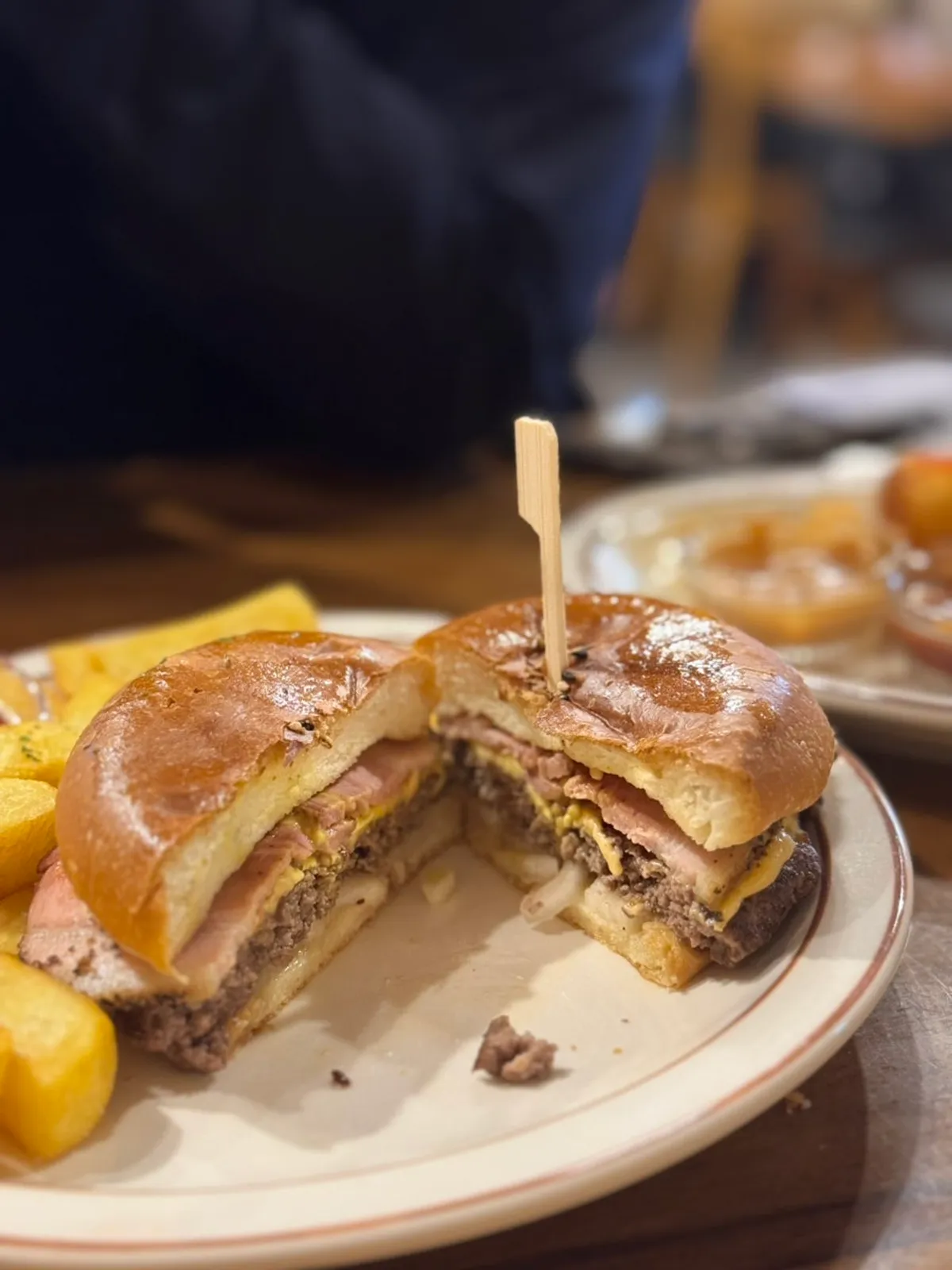 Cross-section of a bacon cheeseburger cut in half