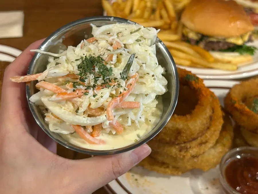 Dipping an onion ring into the sauce