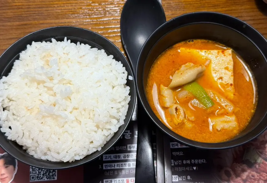 Full table spread of gopchang hot pot and rice