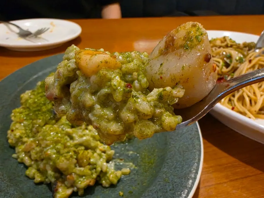 A spoonful of gim pesto risotto lifted from the plate