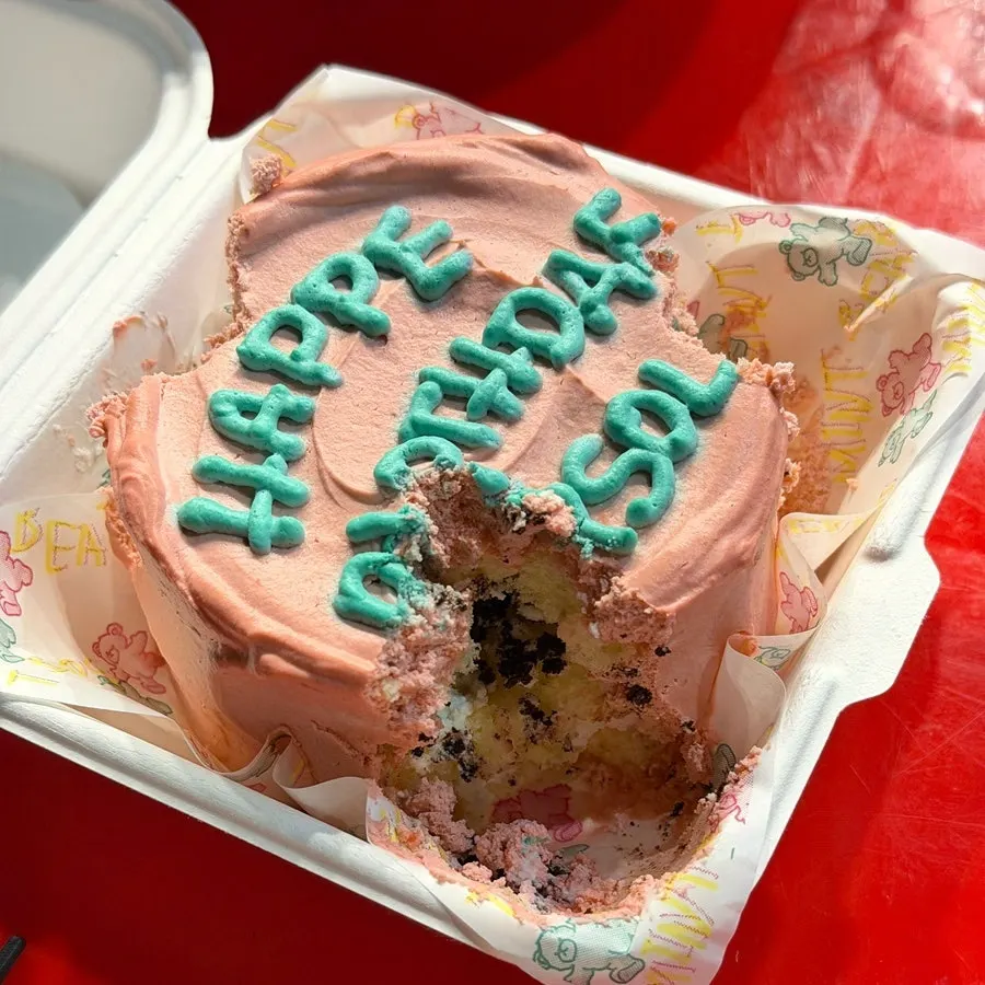 Enjoying the birthday cake at an outdoor bar tent