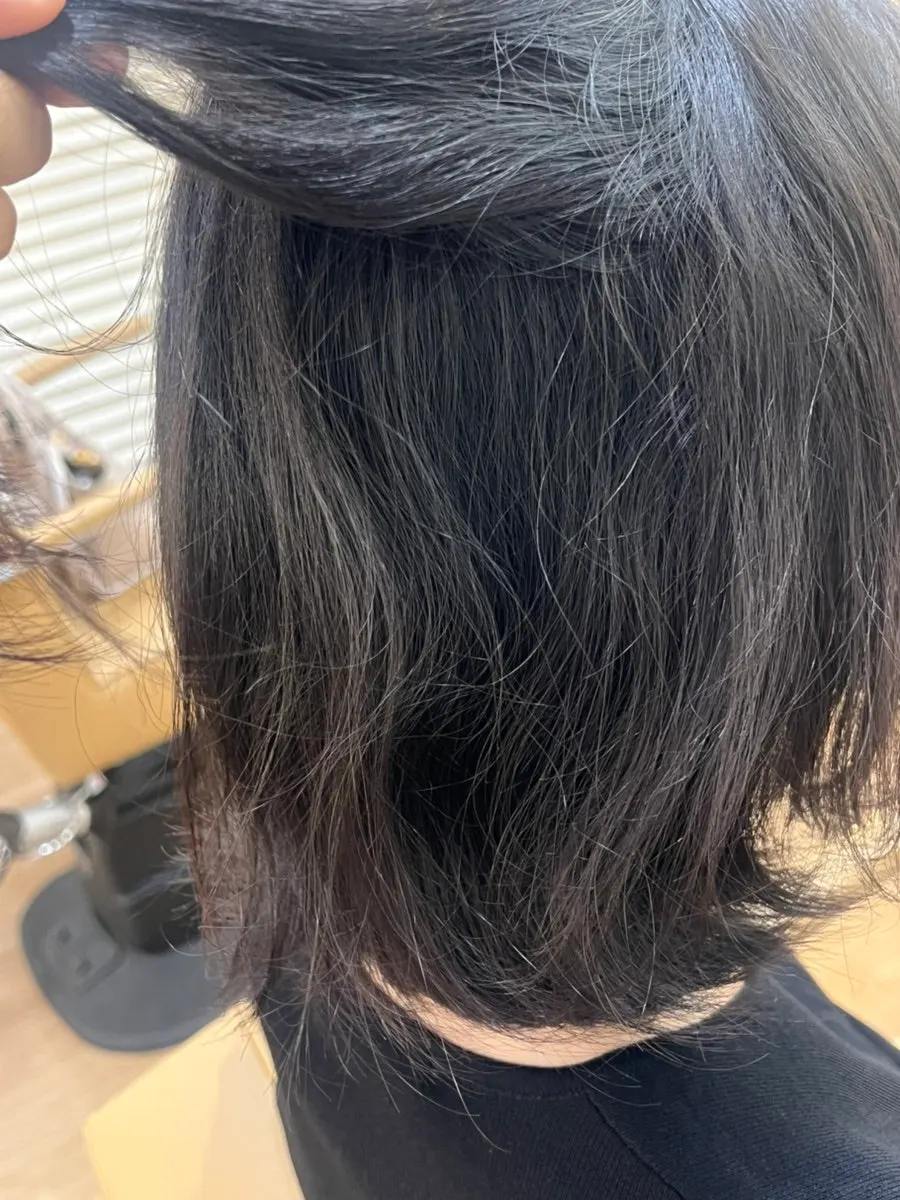 Semi-curly hair before treatment, grown out from a tassel cut
