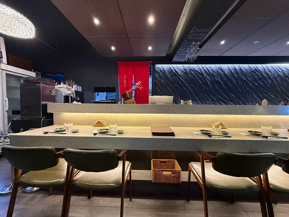Prep station visible through the red noren curtain