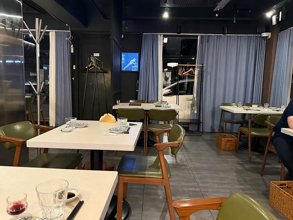 Table seating for four with green leather chairs