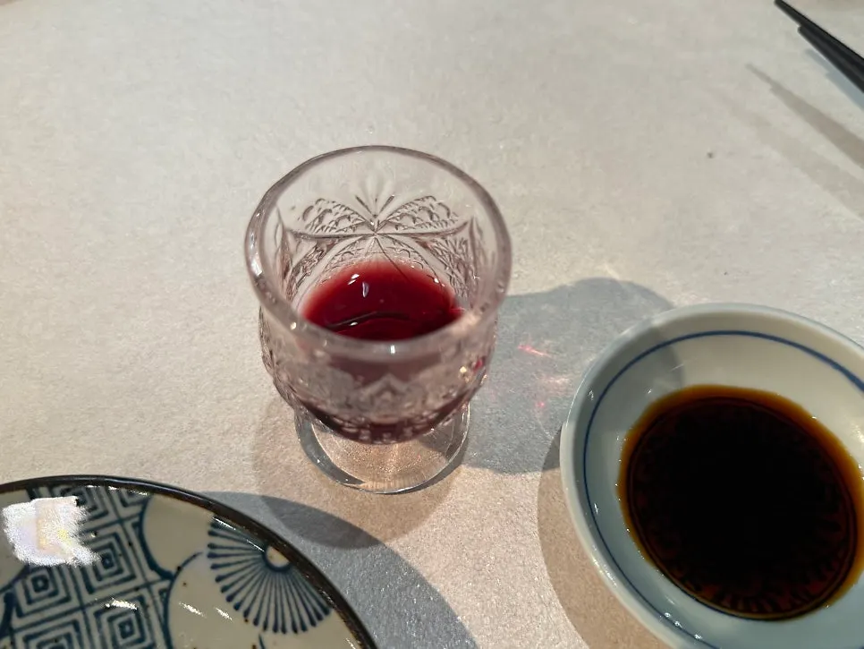 Red aperitif in a small crystal glass