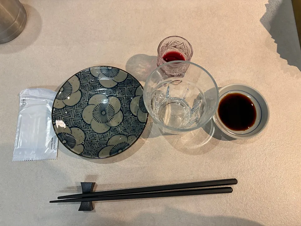 Table setting with a floral plate and soy sauce dish