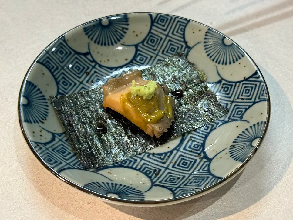 Abalone with innards served on seaweed