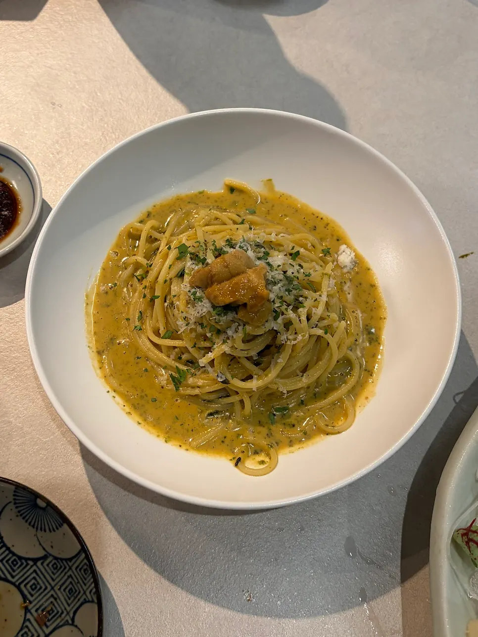 Uni pasta topped with a whole sea urchin roe