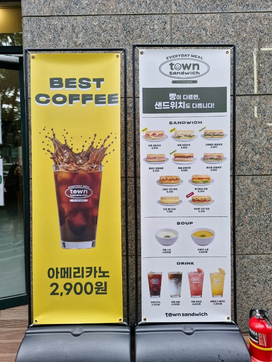 Menu standing sign in front of Town Sandwich