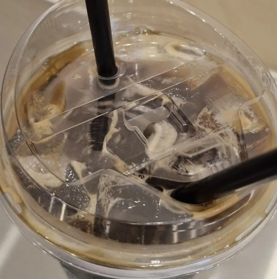 Iced americano with a straw inserted