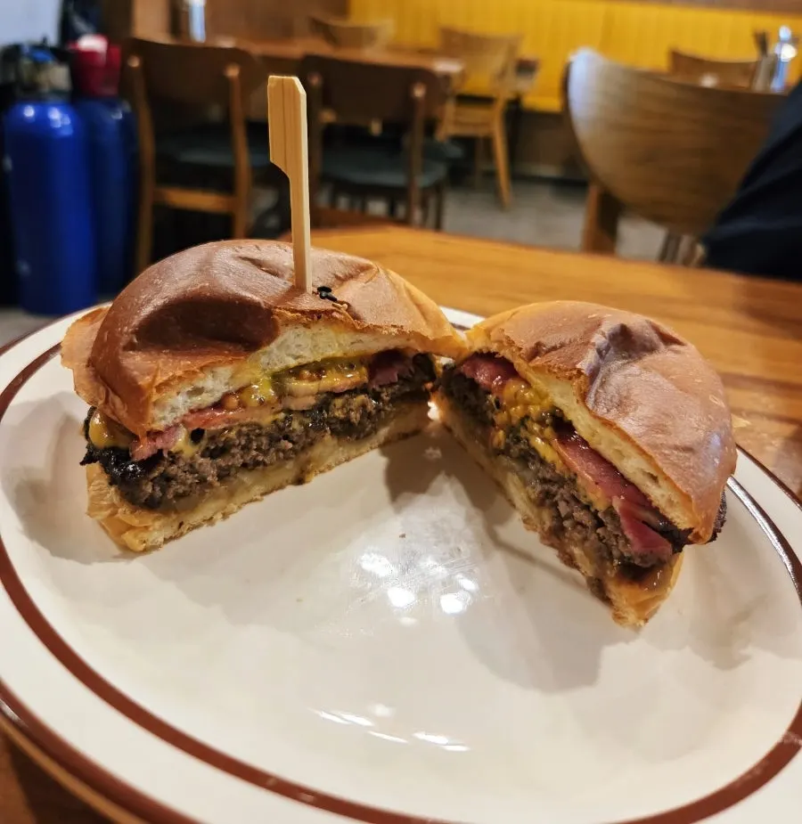 Cross-section of the burger showing bacon and cheese