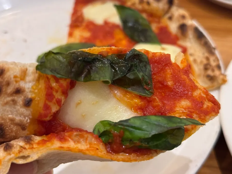 Margherita pizza topped with basil