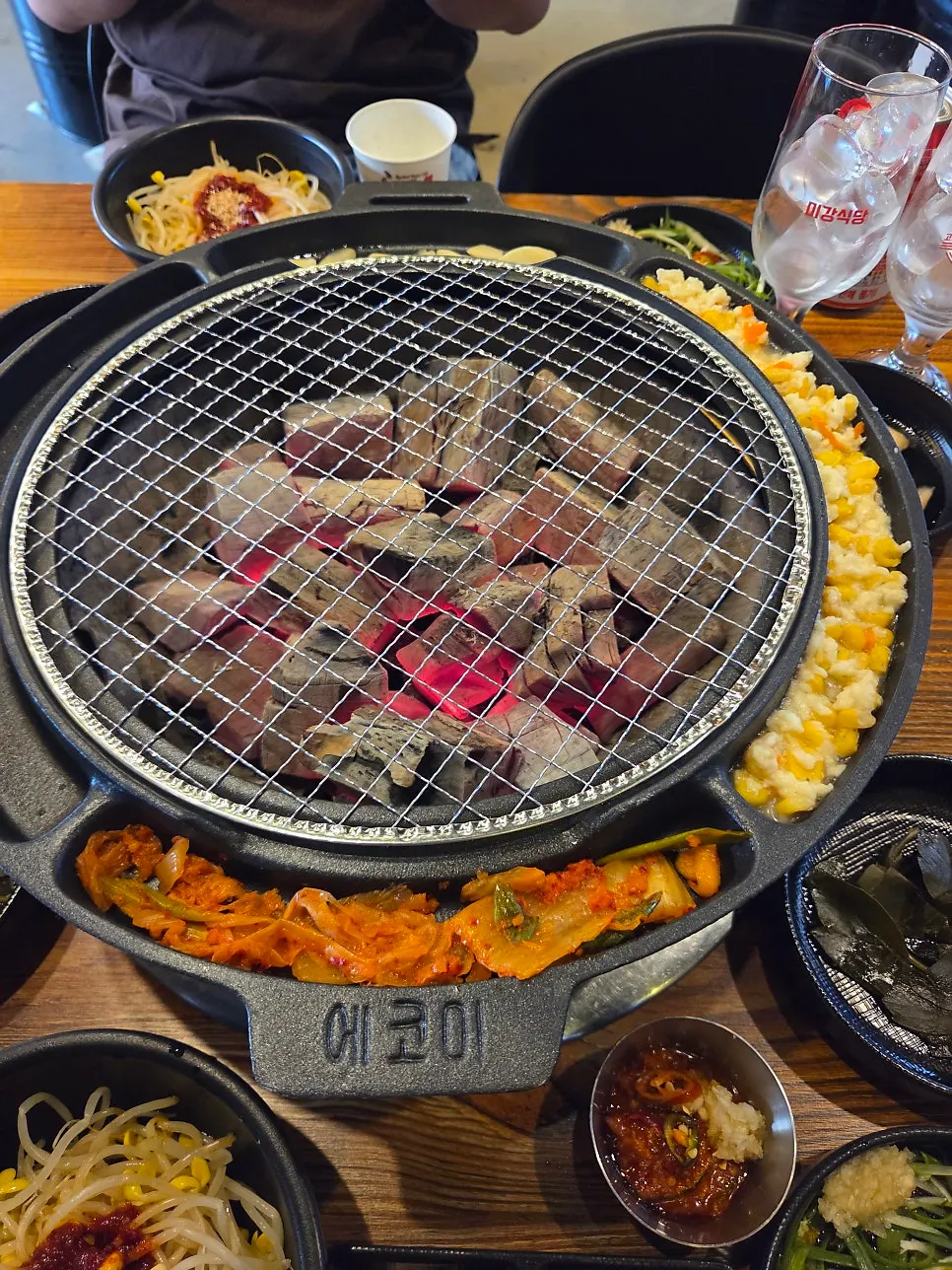 Steamed egg and corn cheese set around the charcoal grill