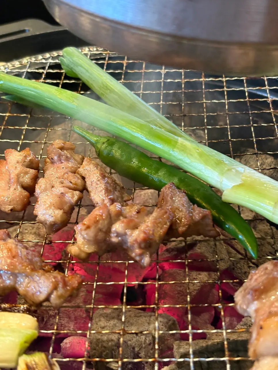 Scored pork neck on the grill