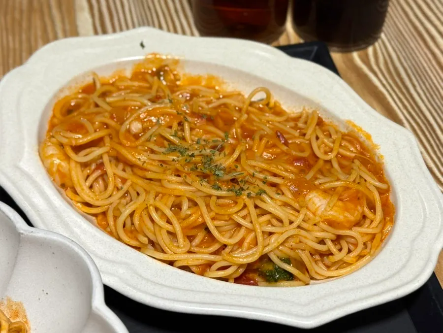 A plate of tomato pasta ordered together