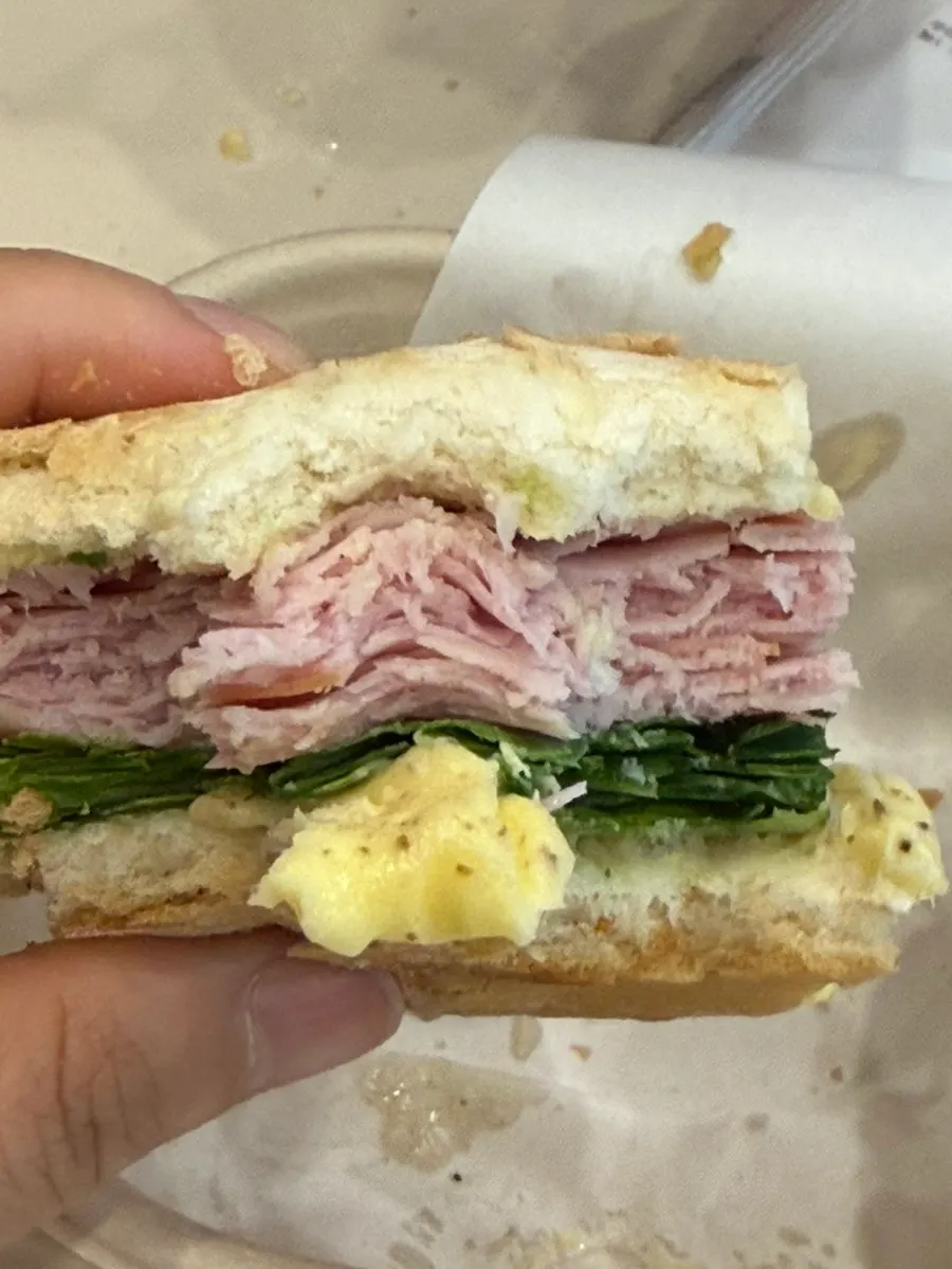 Bite-mark cross-section of the crusty-outside-soft-inside same-day baguette sandwich