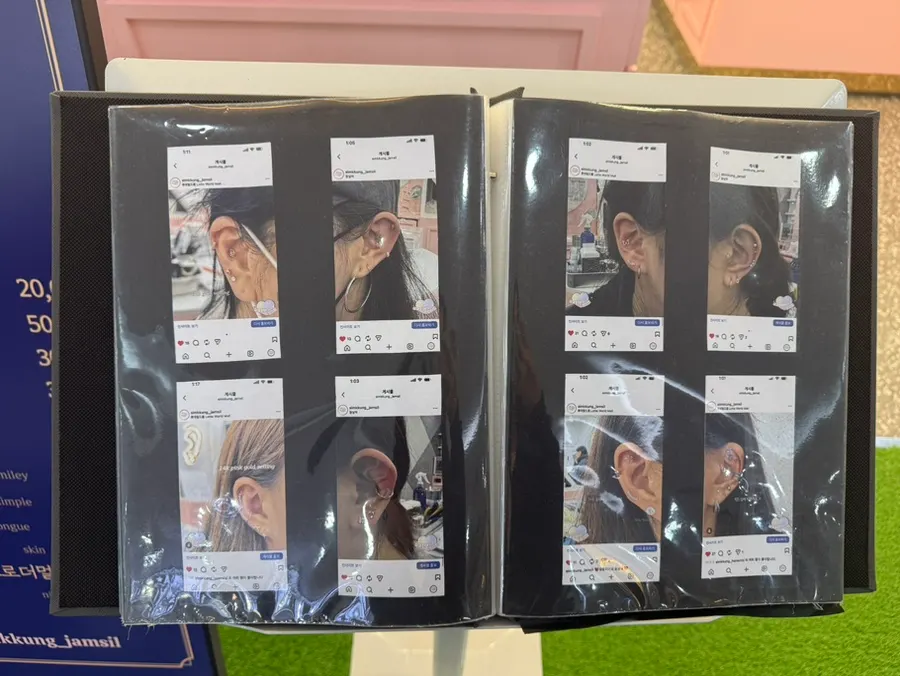 Photos of customer piercings displayed in the shop