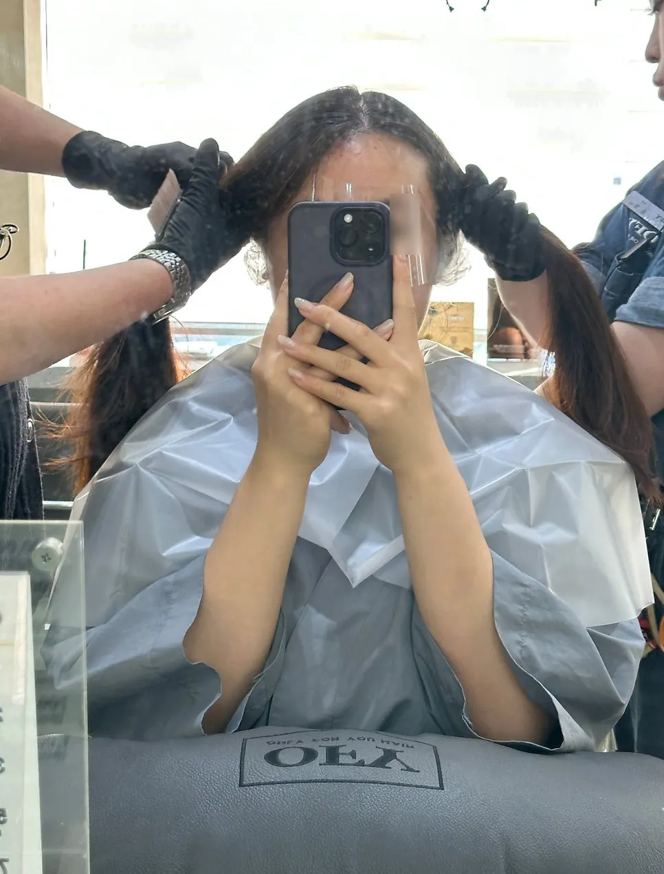 Two designers dyeing hair at the same time