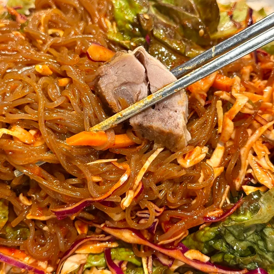Mixing the jaengban guksu before eating
