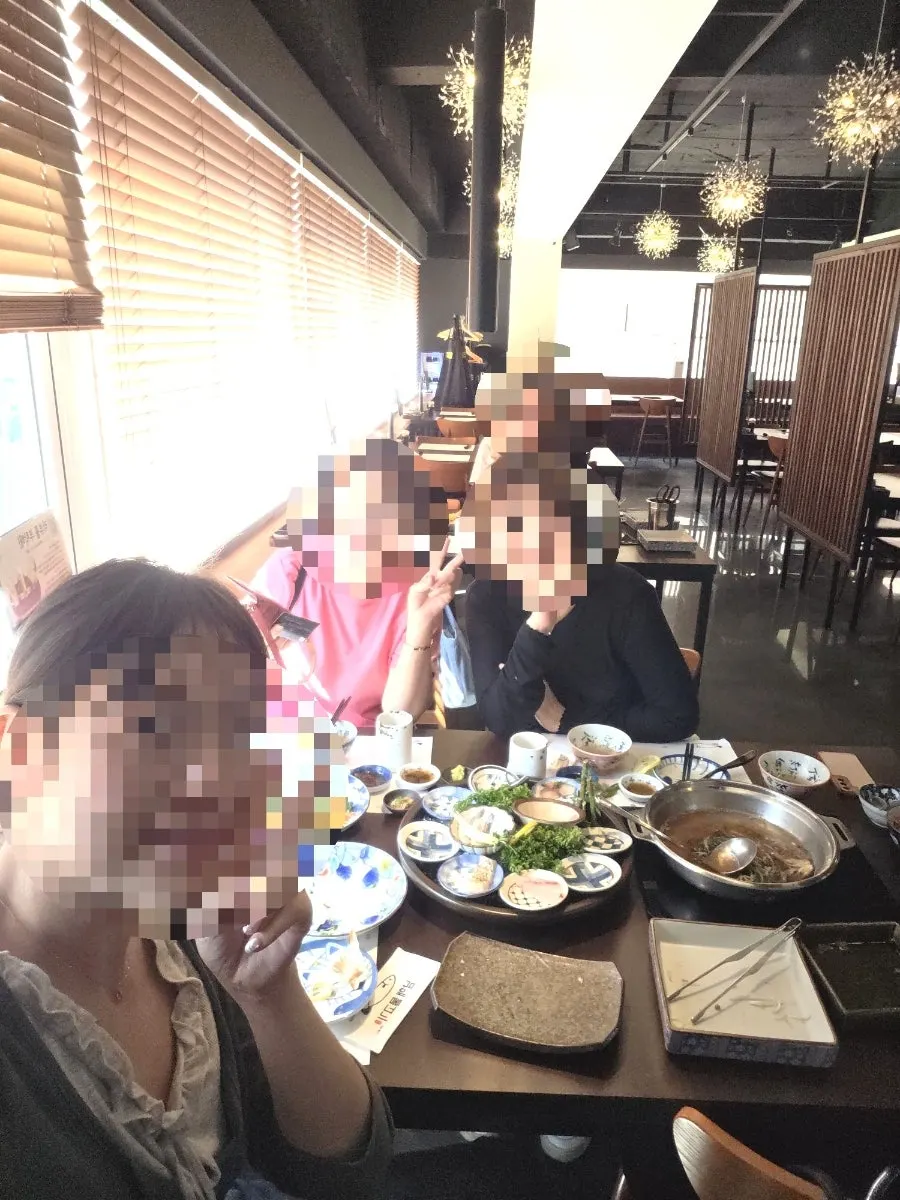 Vertical shot of family gathering table at Jamsilsaenae sashimi restaurant