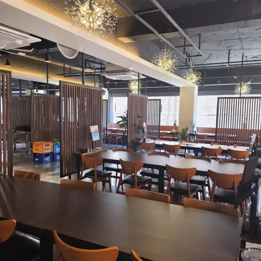Interior of Namhae Fish Jamsilsaenae Branch with generously spaced tables