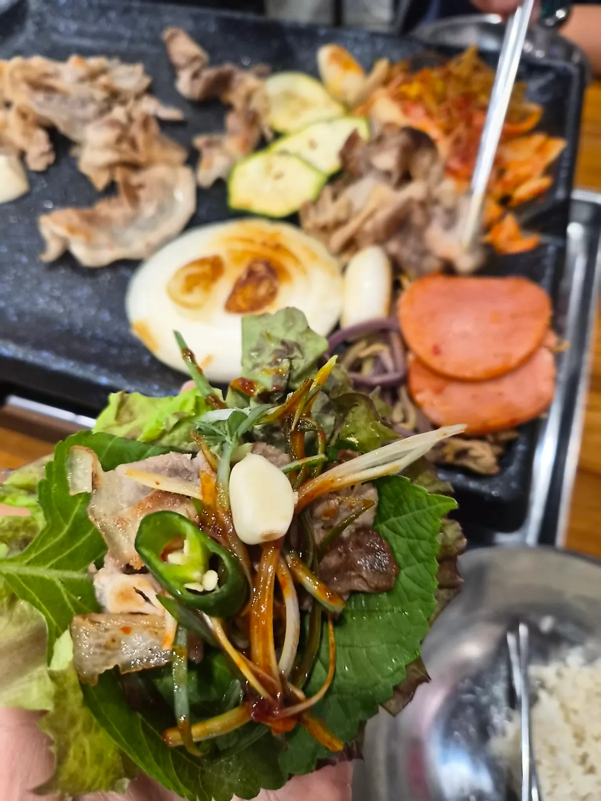 Sliced pork belly and grilling ingredients cooking on the grill