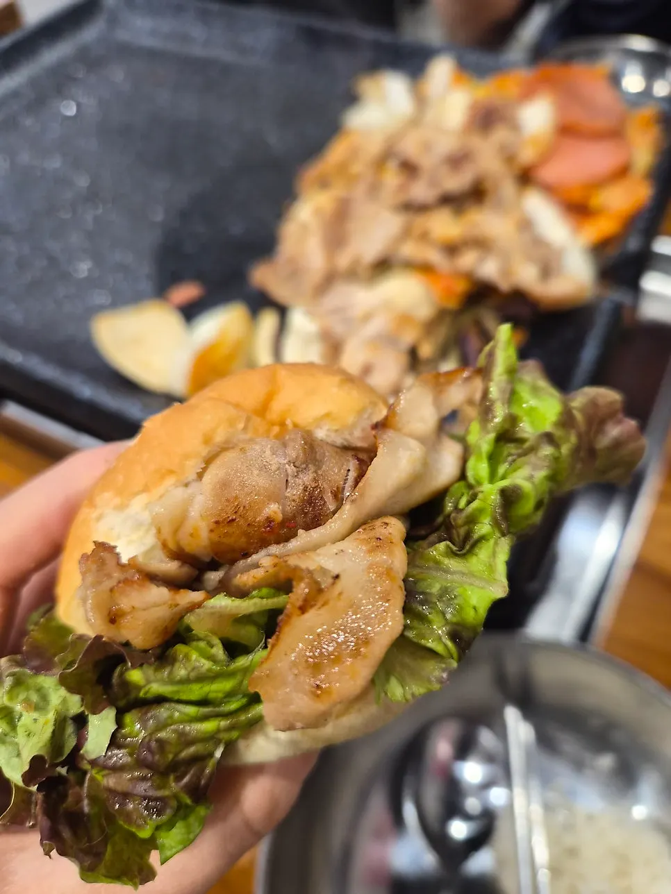Well-grilled sliced pork belly with a plate of sauces