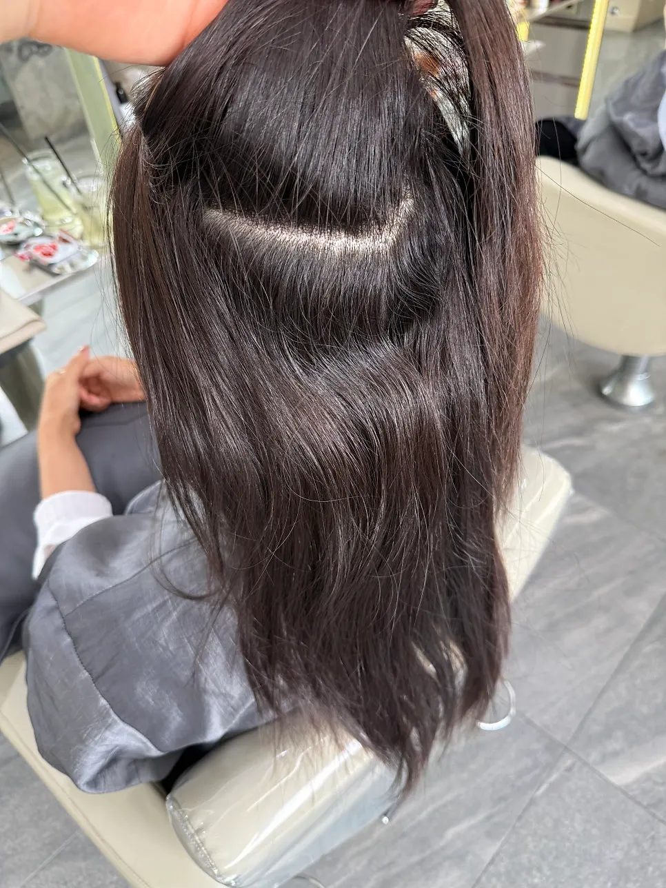 Before shot showing the line between previously straightened hair and new curly roots