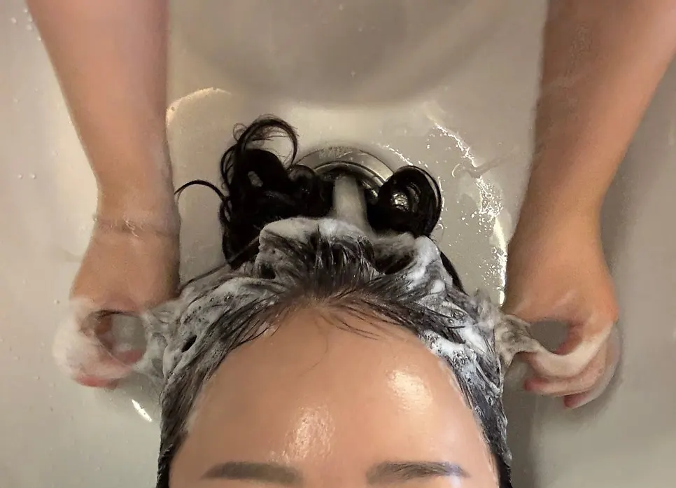 Hair being washed with the clinic shampoo
