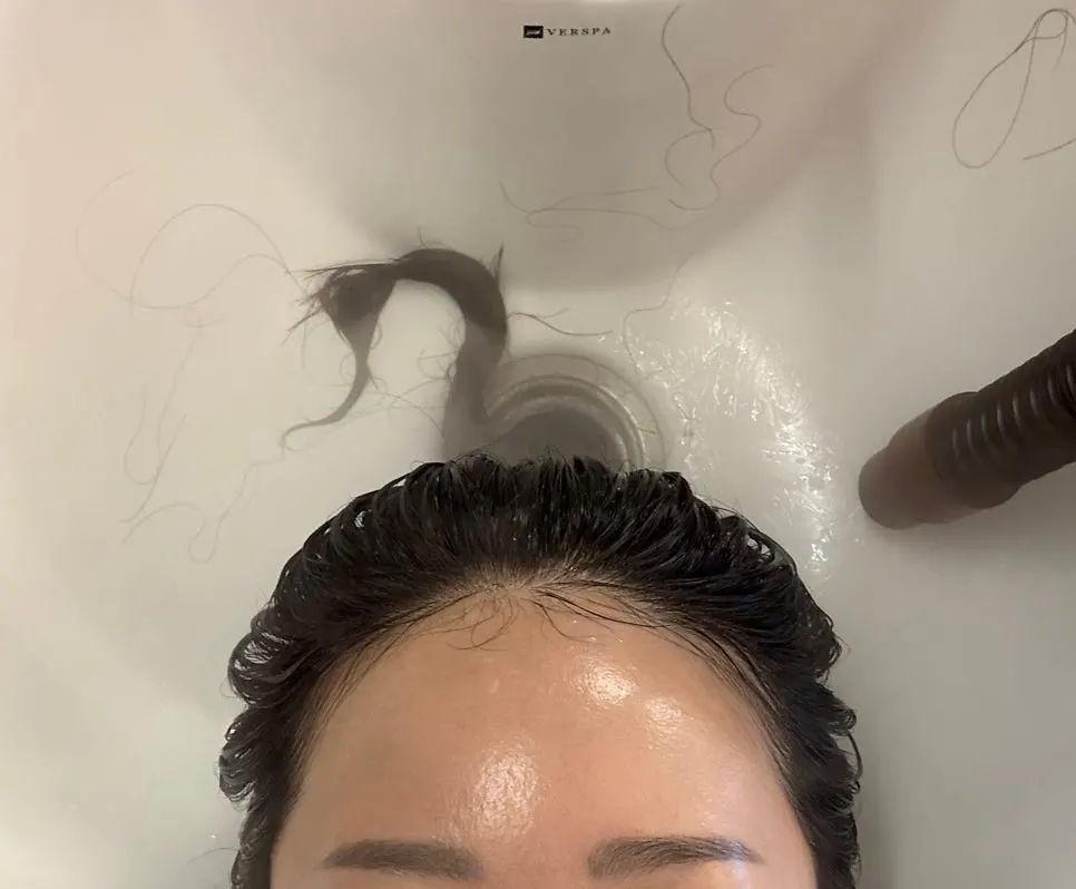Milbon clinic product being applied to the hair