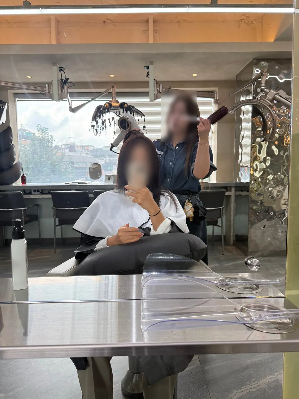 Heat-protectant mist being sprayed before blow-drying