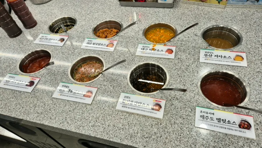Self-serve side dish bar with mushrooms and seasoned bean sprouts
