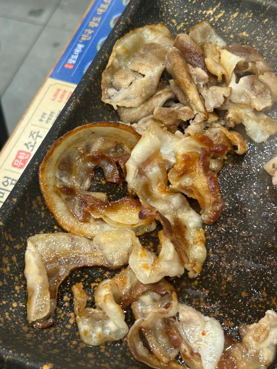 Plate of bright red shaved pork brought from the meat fridge