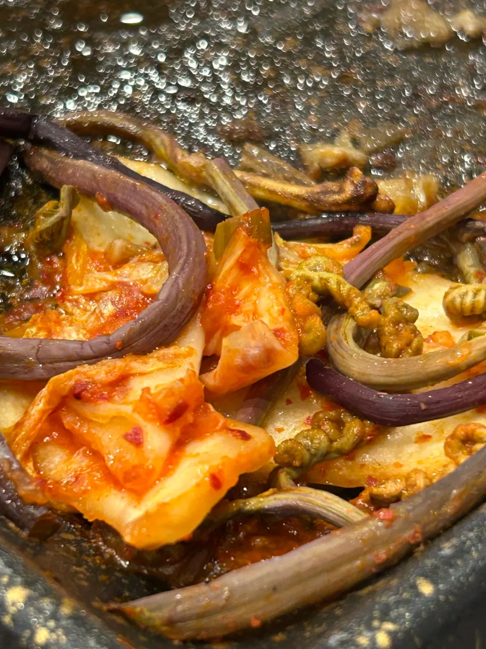 Shaved pork piled onto the hot grill