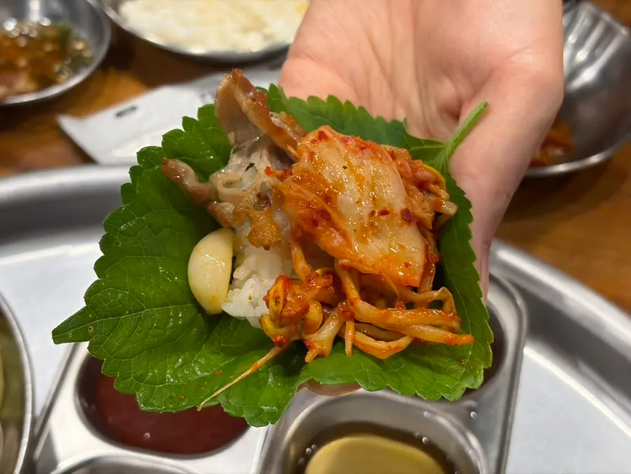 Kimchi and vegetables grilled on the pan alongside the meat