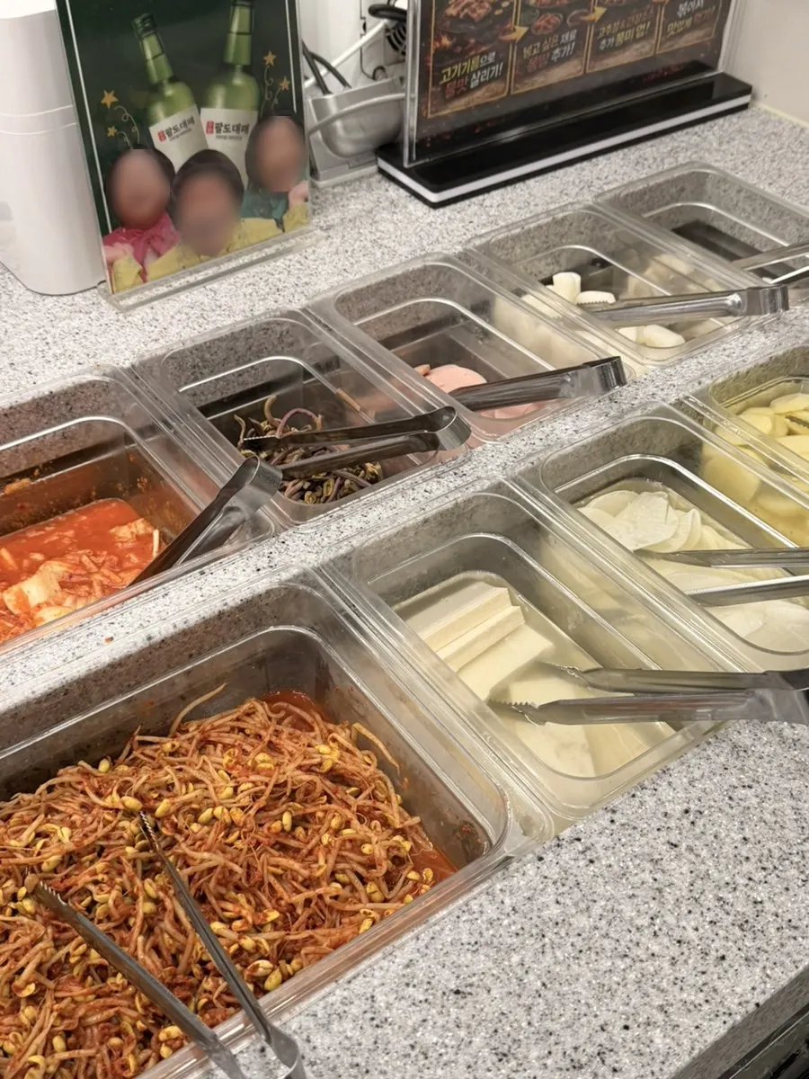 Tteokbokki and side dishes at the self-serve bar
