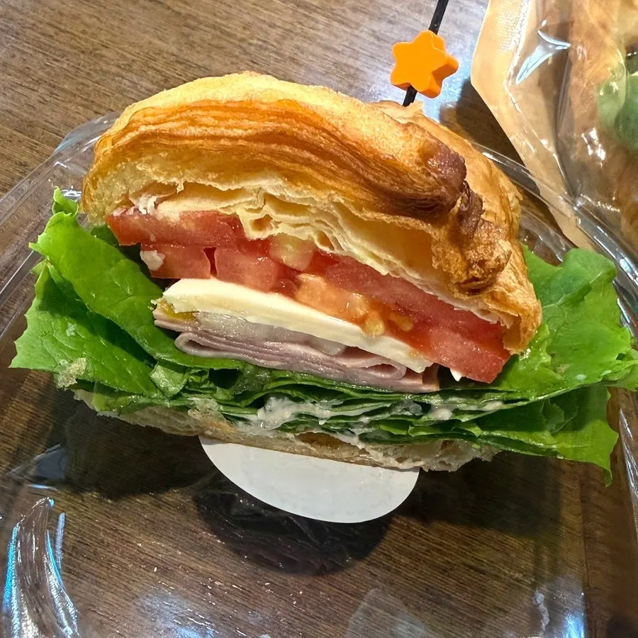 Cross-section of croissant sandwich thick with ham and cheese