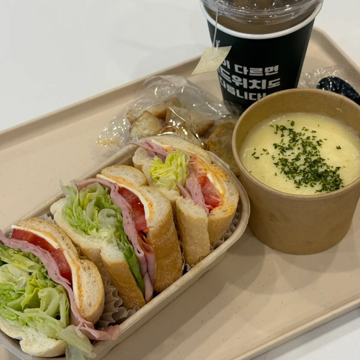 All-in-one set spread with sandwich, soup, and chamomile tea