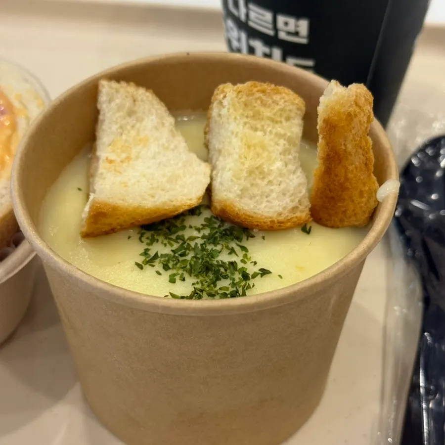 Cream soup served with baguette croutons
