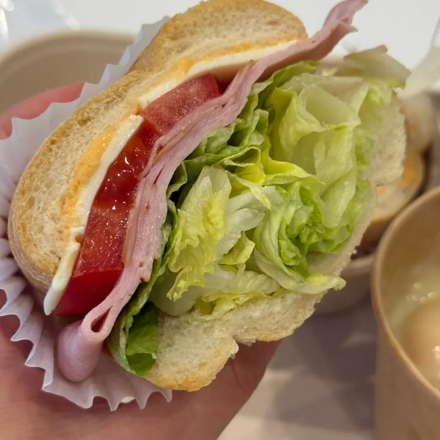 A piece of the baguette sandwich held in hand