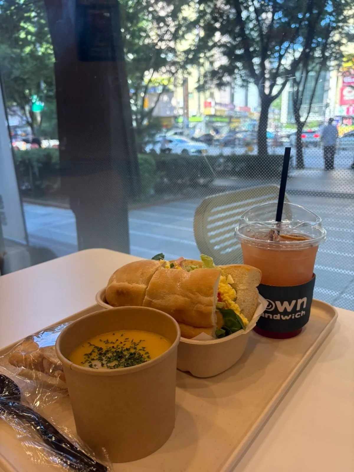 Table setup with Town Sandwich topped with rocket and tomato, plus pumpkin soup