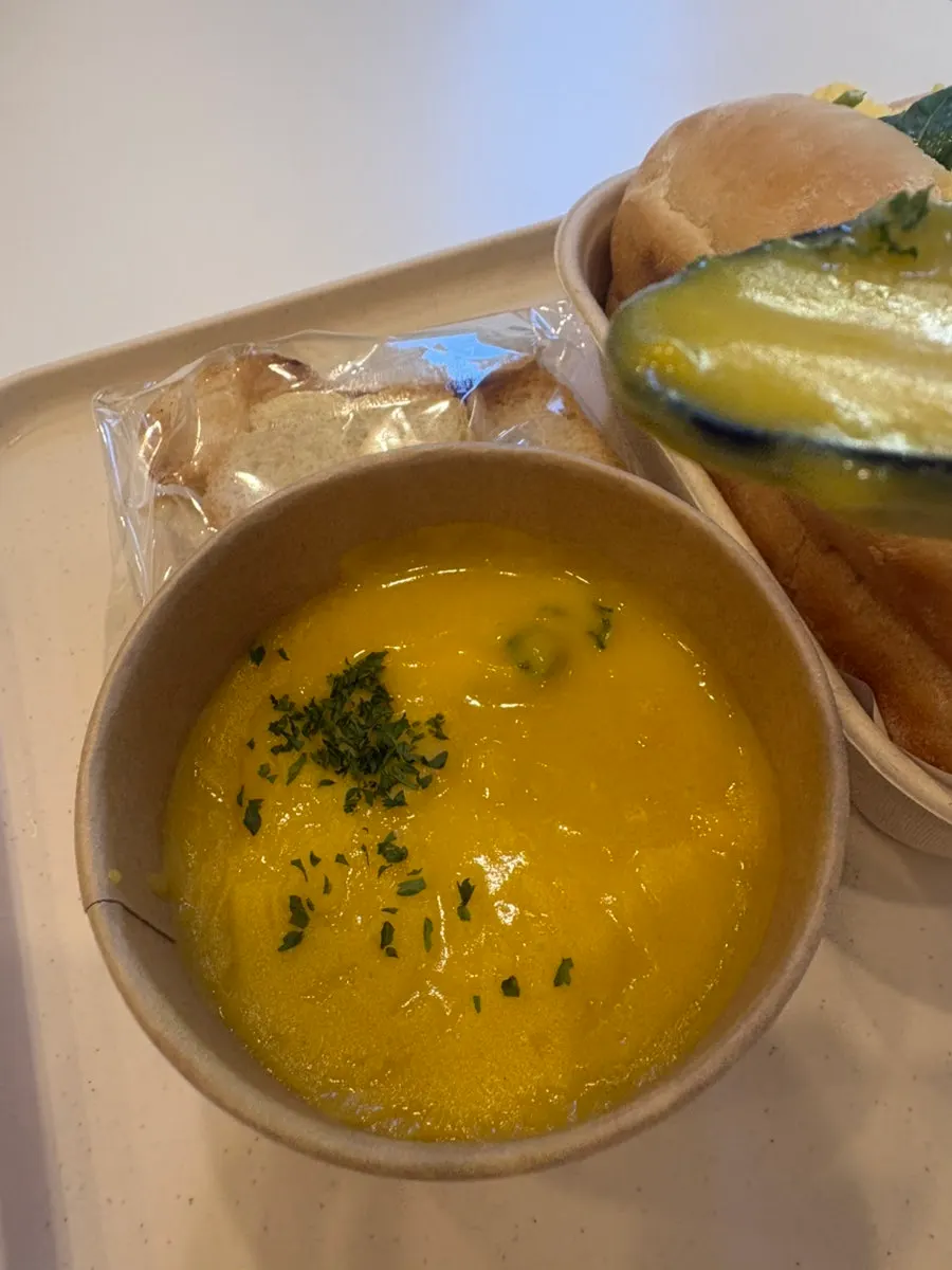 Warm pumpkin soup served with a side of baguette