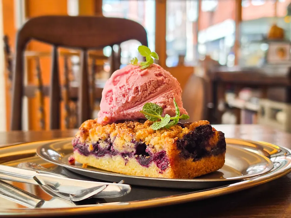 Plate of summer berry crumble cake with ice cream