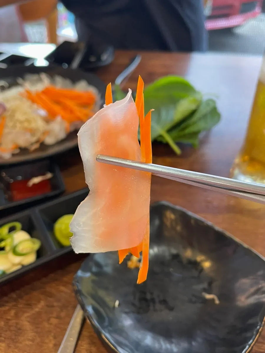 Ojingeopo sliced thin enough to see the carrot behind it