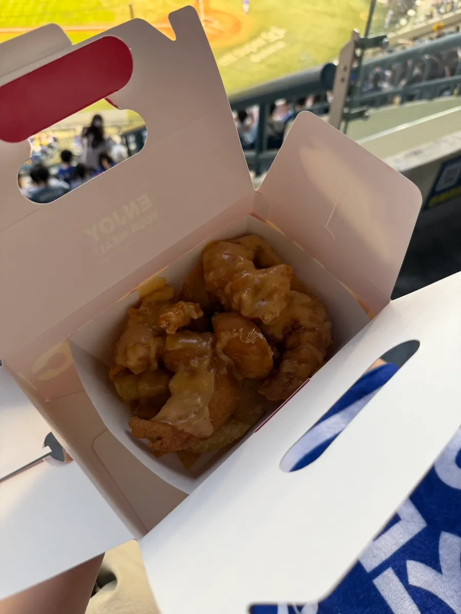 A full spread of stadium food laid out on the seat