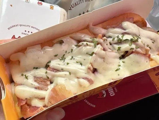 The bacon corn mayo hot dog packaged for takeout