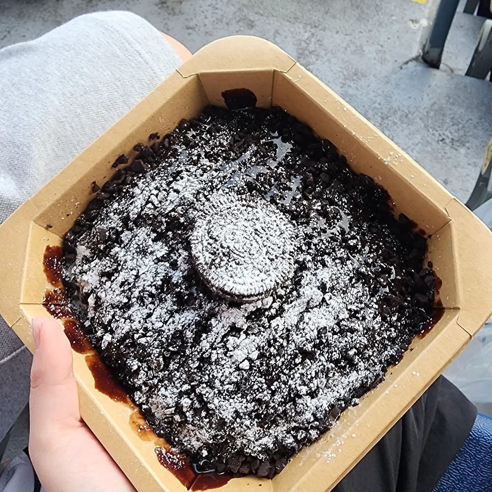 A spoonful of Oreo bingsu covered in sugar powder
